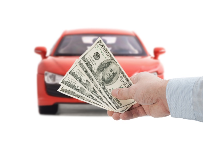 man holding cash in front of car