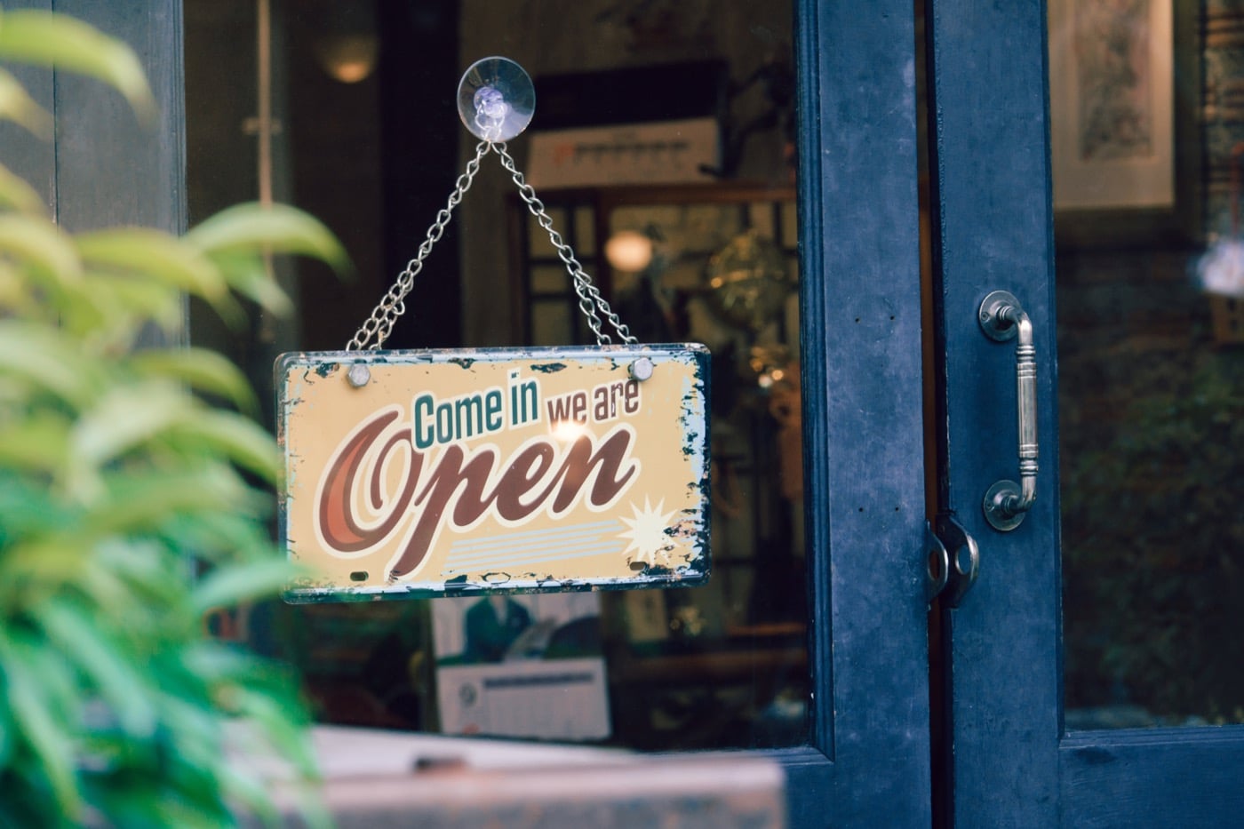 Open sign on a PostcardMania door