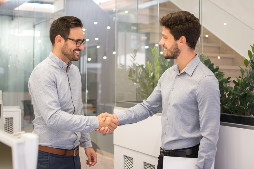 two men shaking hands at the office