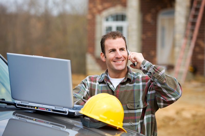 man with hard hat on the phone