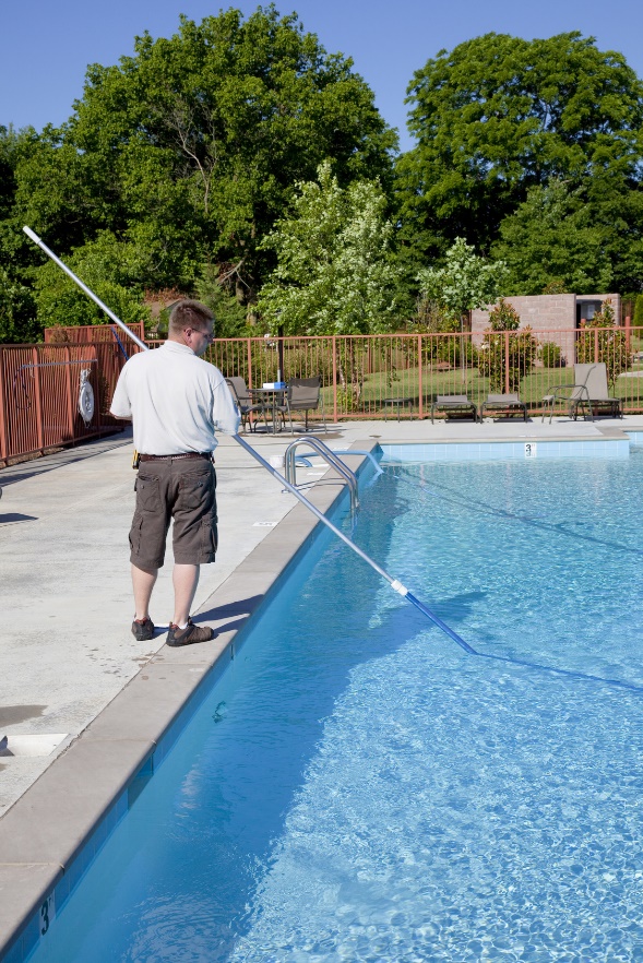 man cleaning pool