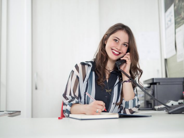 receptionist answering phone call at dental practice